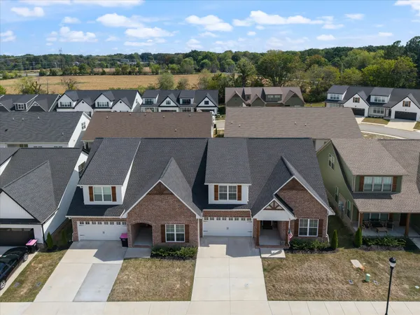 an aerial view of a house with swimming pool and sitting area