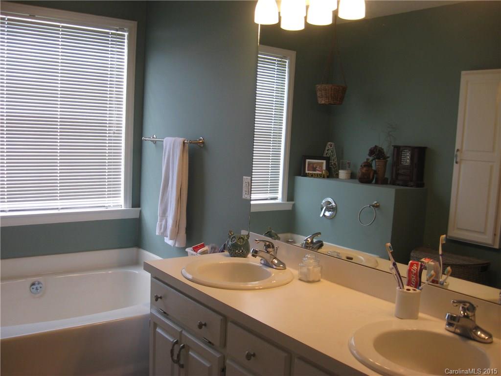6106 Olive Branch Road Wingate, NC 28174 - Photo 11 of 19 a bathroom with a granite countertop sink and a mirror