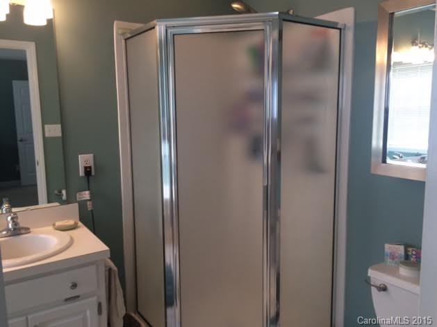 6106 Olive Branch Road Wingate, NC 28174 - Photo 12 of 19 a bathroom with a sink and mirror with toilet