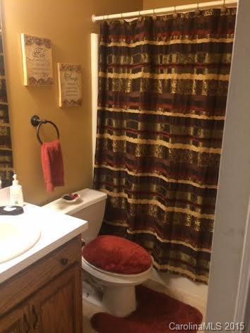 6106 Olive Branch Road Wingate, NC 28174 - Photo 13 of 19 a bathroom with a sink toilet and shower