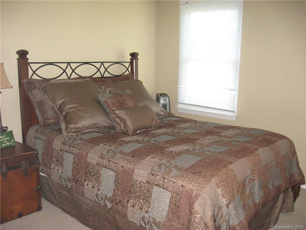 6106 Olive Branch Road Wingate, NC 28174 - Photo 14 of 19 a large bed sitting in a bedroom next to a window