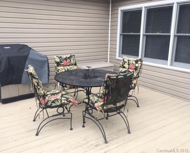 6106 Olive Branch Road Wingate, NC 28174 - Photo 16 of 19 a view of a patio with table and chairs and potted plants