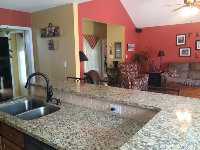 6106 Olive Branch Road Wingate, NC 28174 - Photo 4 of 19 a kitchen with granite countertop a sink and a stove