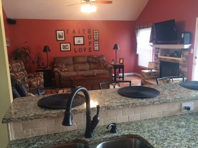 6106 Olive Branch Road Wingate, NC 28174 - Photo 5 of 19 a room with granite countertop a sink and a stove