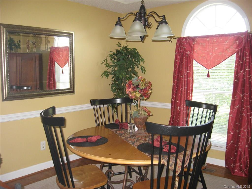 6106 Olive Branch Road Wingate, NC 28174 - Photo 7 of 19 a view of a dining room with furniture window and wooden floor