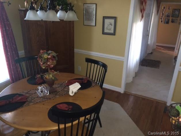 6106 Olive Branch Road Wingate, NC 28174 - Photo 8 of 19 a view of a dining room with furniture and wooden floor