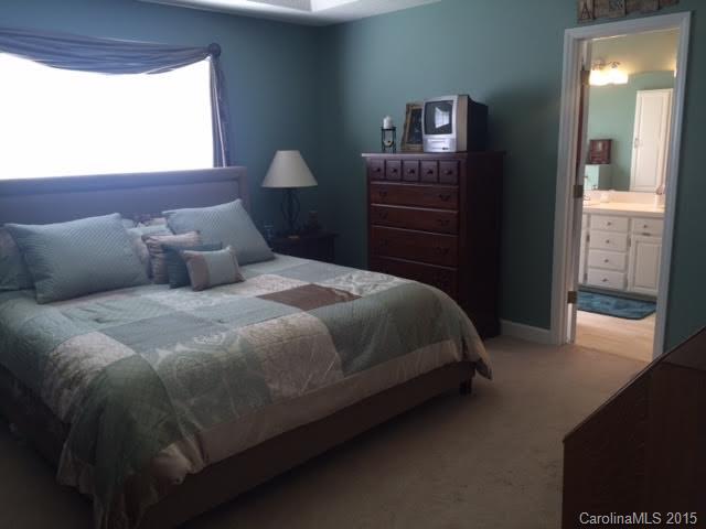 6106 Olive Branch Road Wingate, NC 28174 - Photo 9 of 19 a bedroom with a bed and a lamp