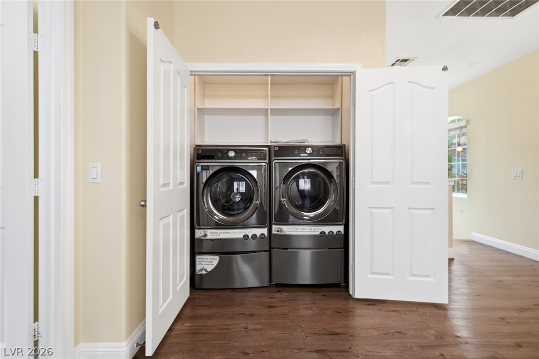 8932 Caledon Ridge Court Las Vegas, NV 89149 - Photo 34 of 39 Double doors open to reveal a built-in laundry station set over handsome wood floors.