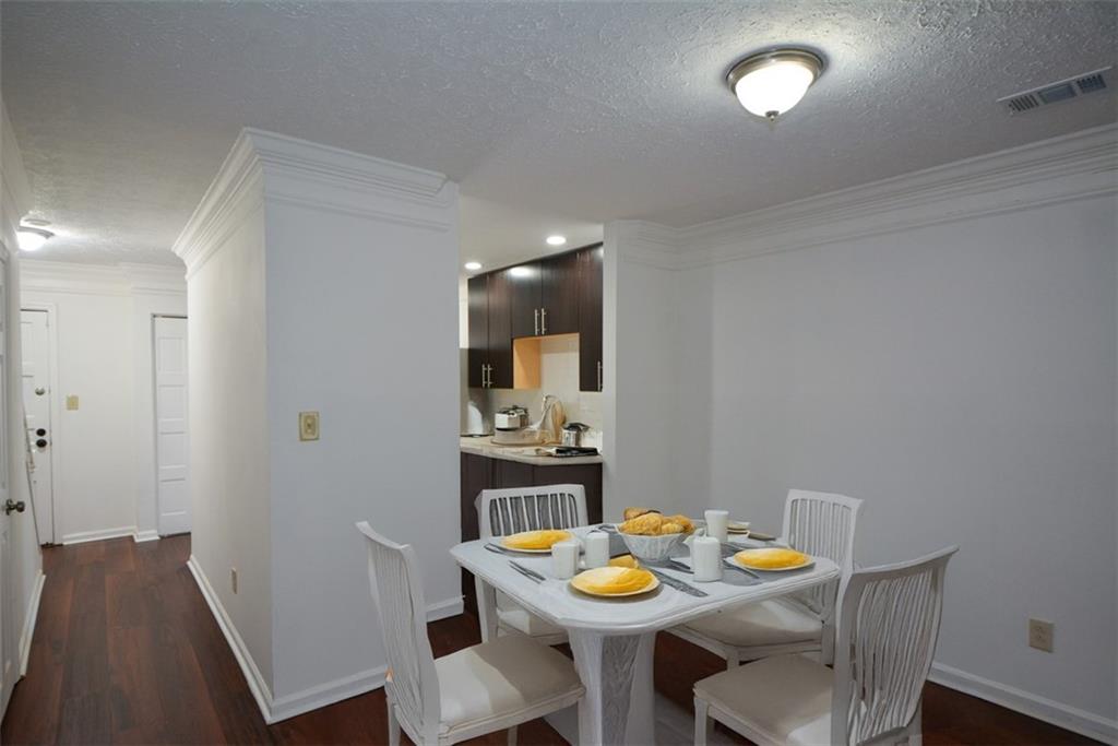 2340 Beaver Ruin Road, Unit UN26 Norcross, GA 30071 - Photo 14 of 42 a view of a dining room with furniture and wooden floor
