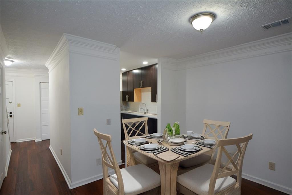 2340 Beaver Ruin Road, Unit UN26 Norcross, GA 30071 - Photo 15 of 42 a view of a dining room with furniture and wooden floor