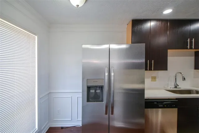 a kitchen with a refrigerator and a sink