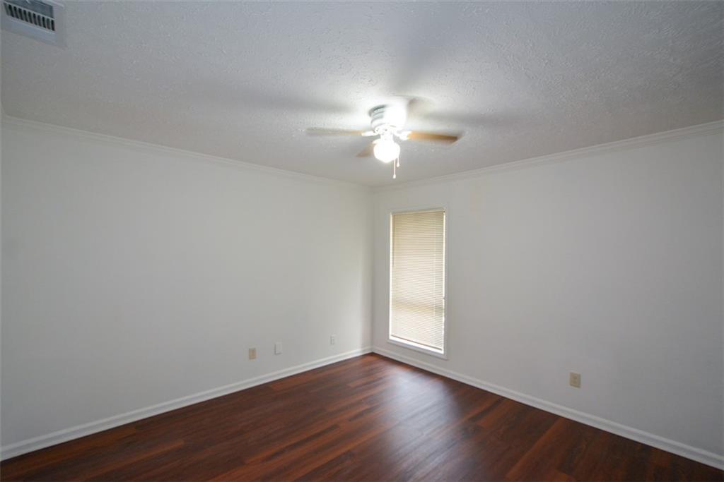 2340 Beaver Ruin Road, Unit UN26 Norcross, GA 30071 - Photo 26 of 42 a view of an empty room with a window and wooden floor