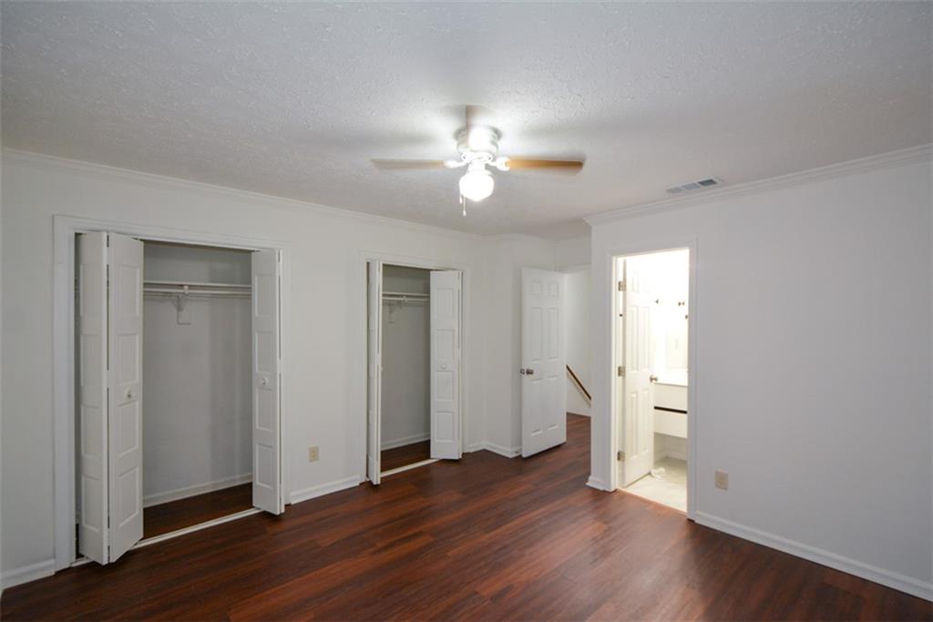 2340 Beaver Ruin Road, Unit UN26 Norcross, GA 30071 - Photo 27 of 42 an empty room with wooden floor and ceiling fan