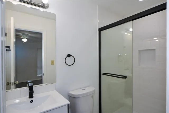 a bathroom with a toilet sink and shower
