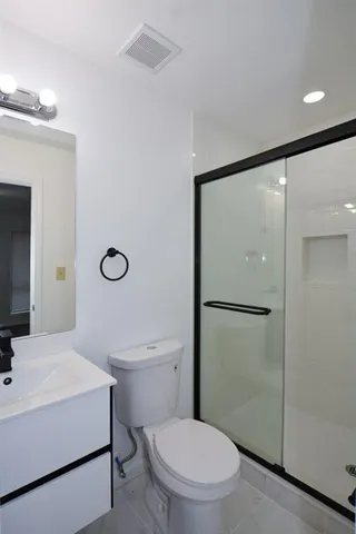 a white toilet sitting next to a bathroom sink