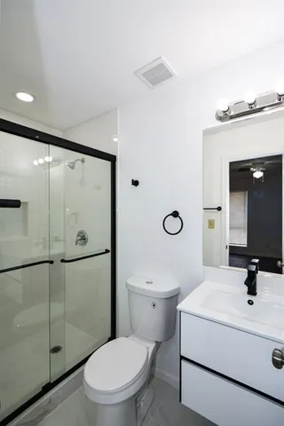 a bathroom with a toilet a sink and a shower