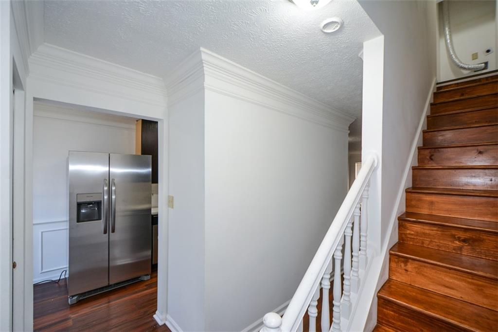 2340 Beaver Ruin Road, Unit UN26 Norcross, GA 30071 - Photo 5 of 42 a view of a hallway with wooden floor and entryway