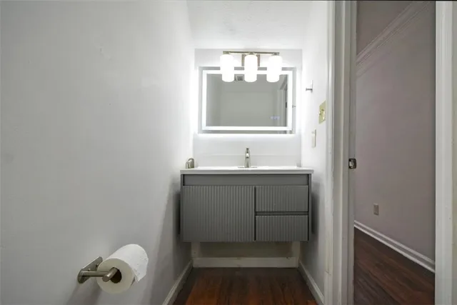 a bathroom with a sink vanity and mirror