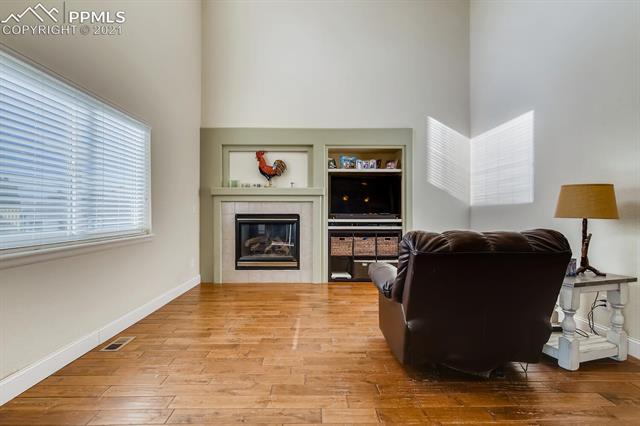 8380 Del Rio Road Peyton, CO 80831 - Photo 11 of 25 Lovely family room with new flooring and cozy fireplace!