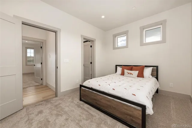 a spacious bedroom with a bed and a view of bathroom