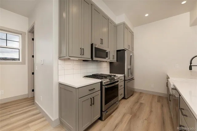 a kitchen with stainless steel appliances granite countertop a stove and a refrigerator
