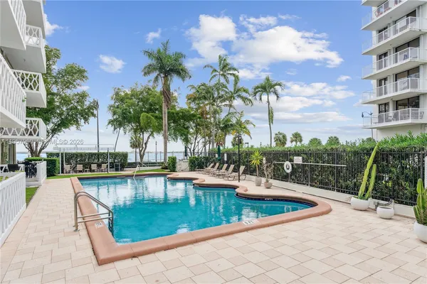 a view of swimming pool with outdoor seating and plants