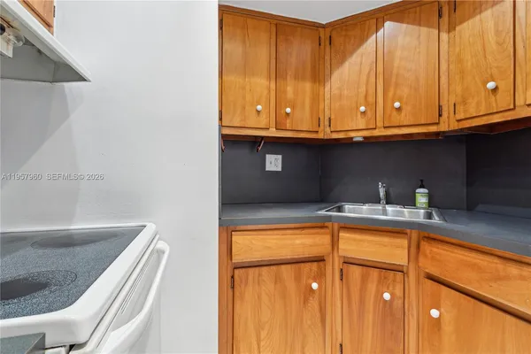 a kitchen with stainless steel appliances granite countertop a sink and a cabinets