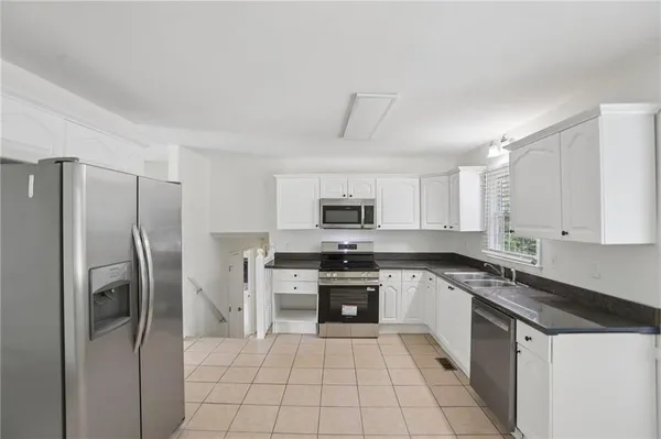 a kitchen with a sink appliances and cabinets