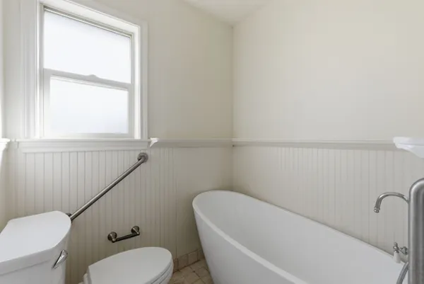 a bathroom with a toilet and a bathtub
