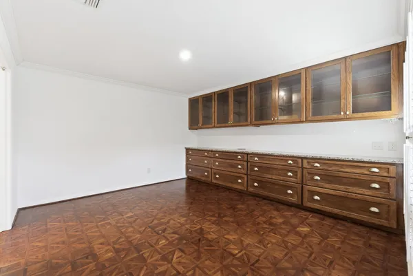 a room with a dresser and a wooden floor
