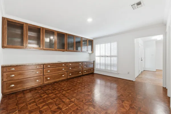 a room with a dresser and a window