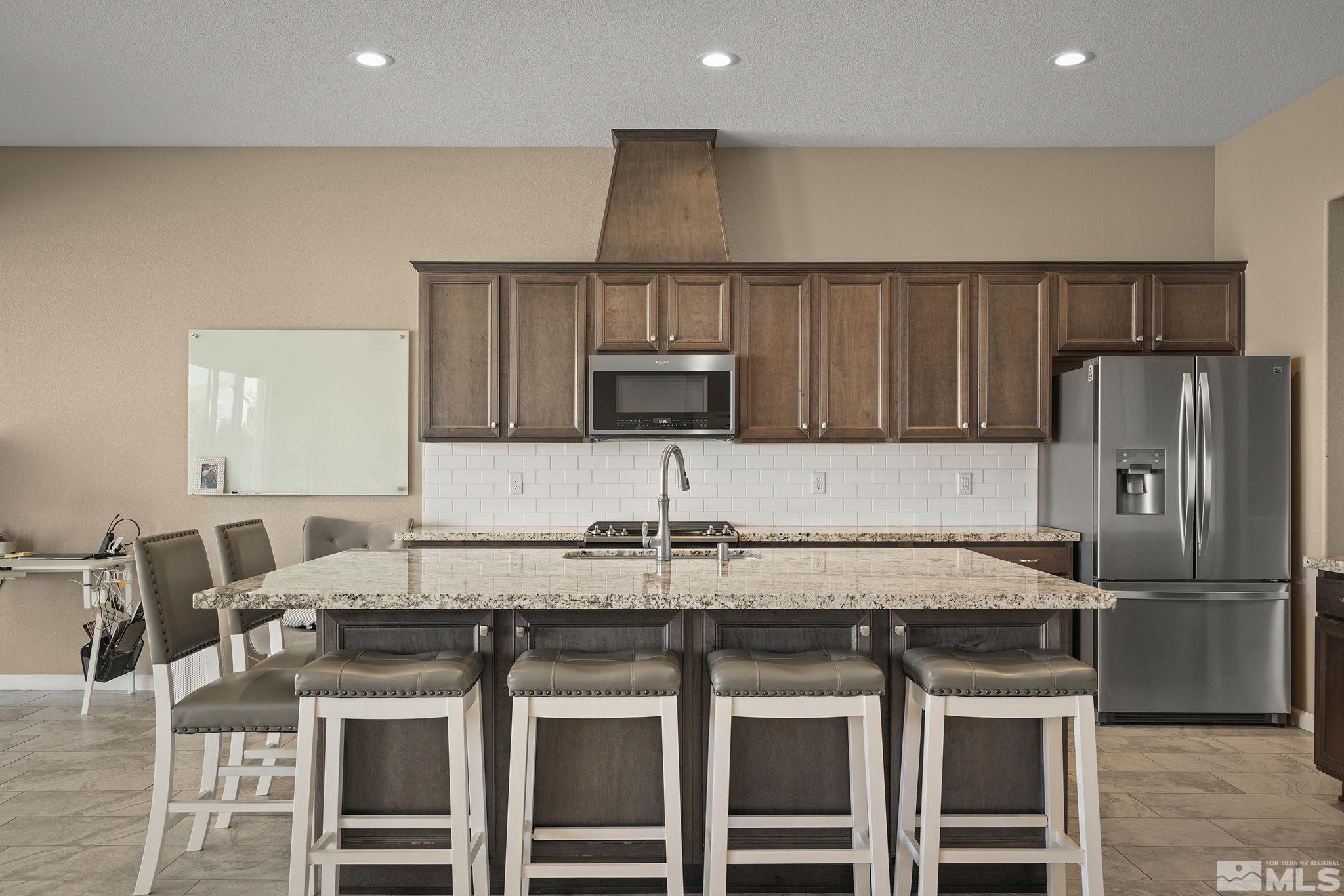 2895 Ethelinda Way Reno, NV 89521 - Photo 6 of 30 a kitchen with stainless steel appliances a stove a sink and a refrigerator