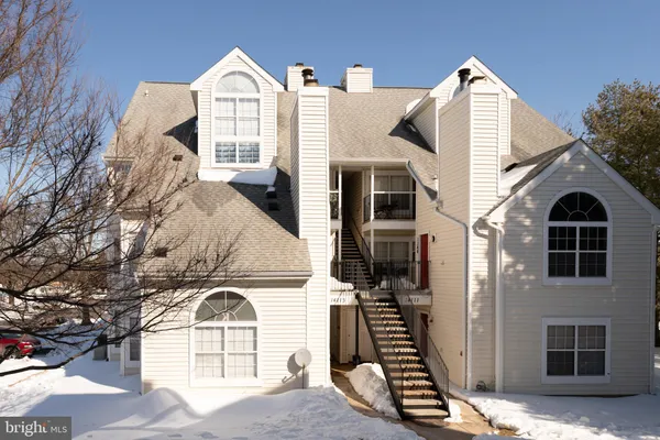 a view of a brick house with large windows