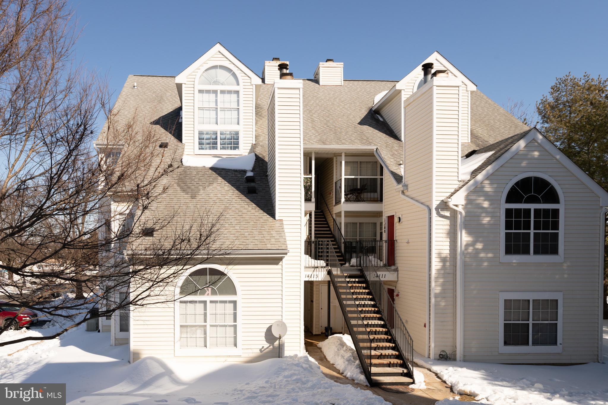 a view of a brick house with large windows