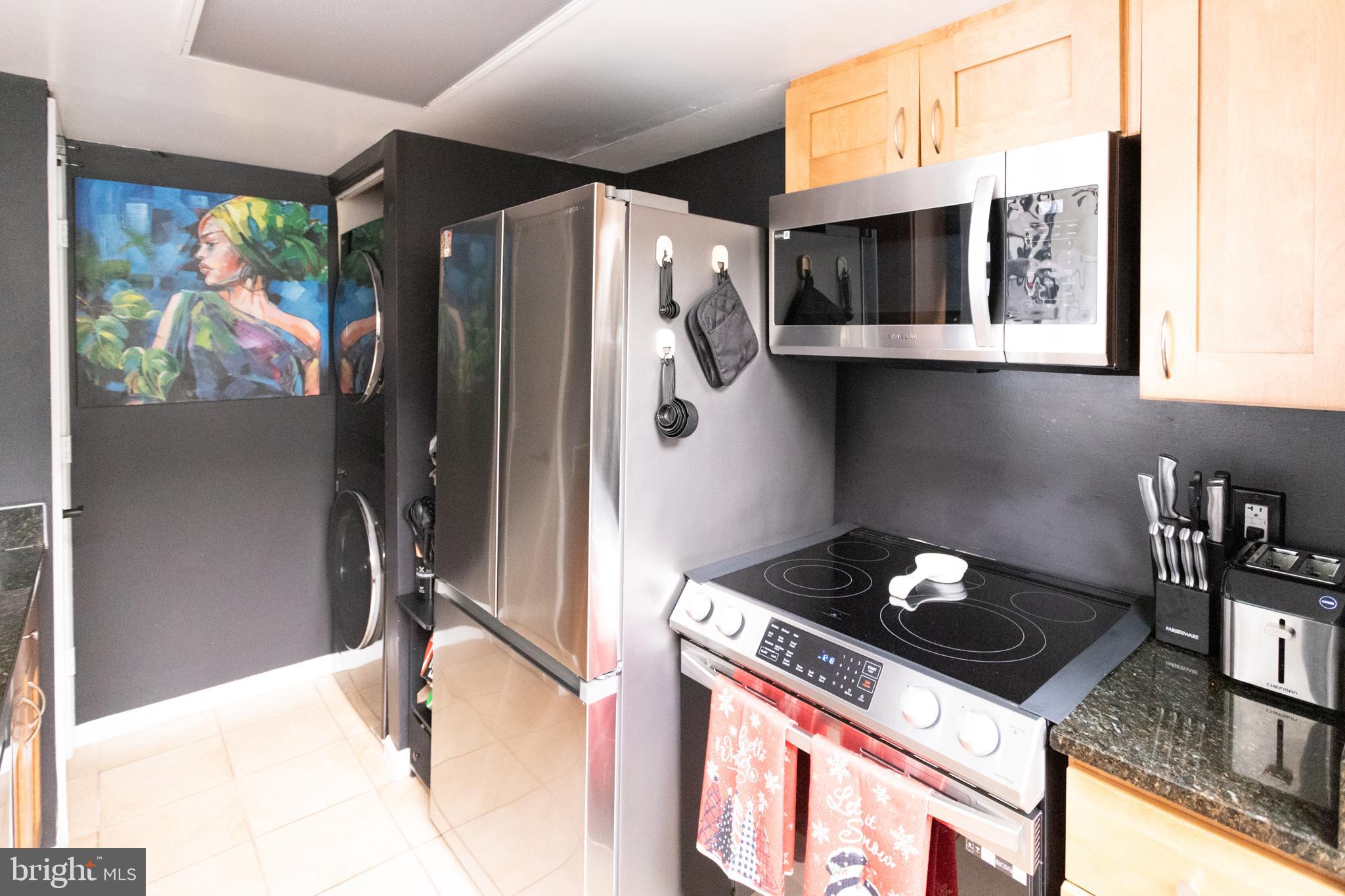 14111 Yardarm Way, Unit 1209 Laurel, MD 20707 - Photo 13 of 29 a kitchen with stainless steel appliances granite countertop a refrigerator and a stove