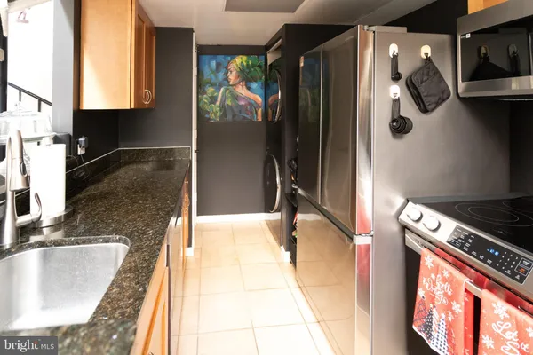 a kitchen with a refrigerator and a sink