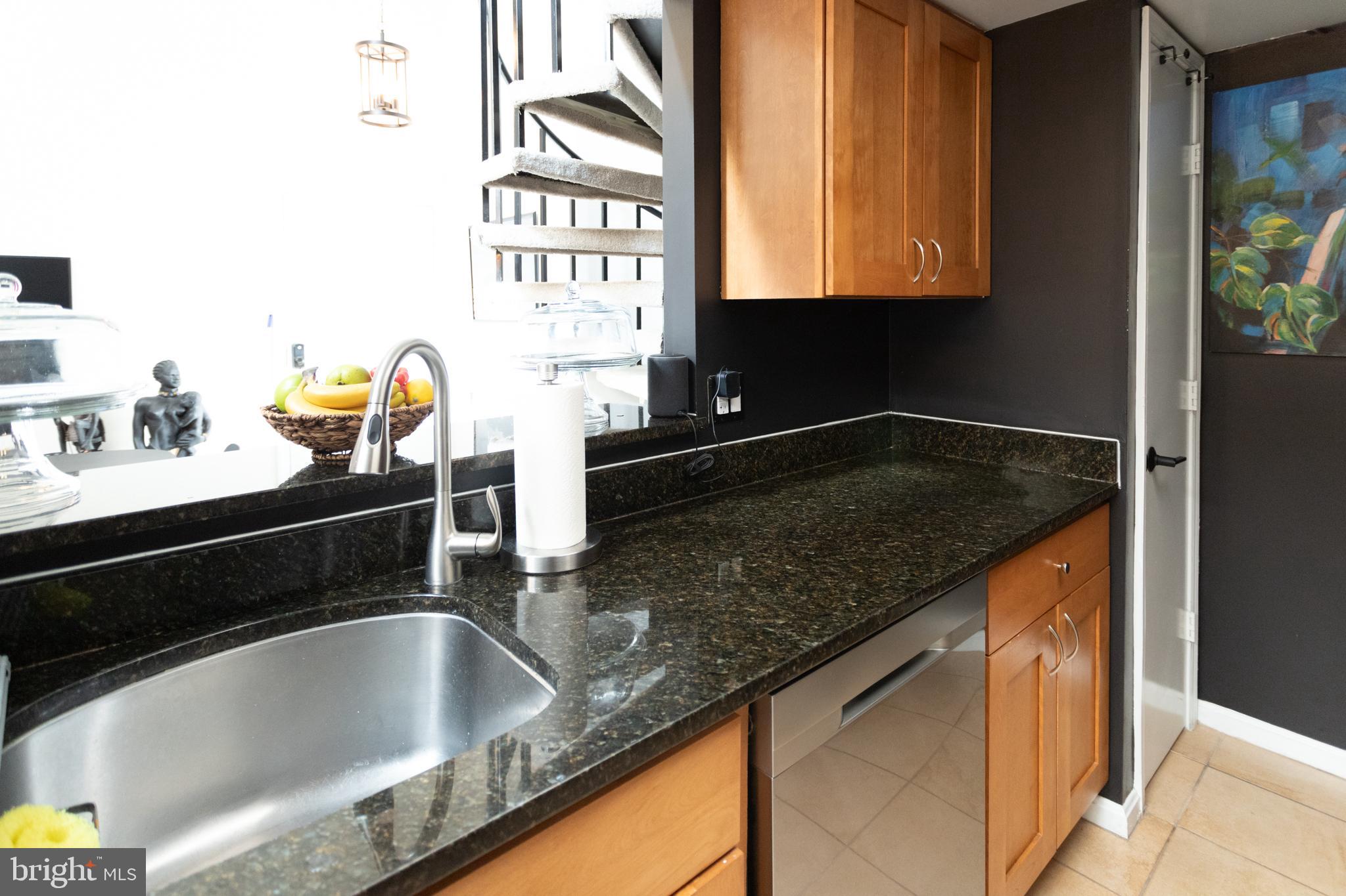 14111 Yardarm Way, Unit 1209 Laurel, MD 20707 - Photo 16 of 29 a kitchen with granite countertop a sink and a stove