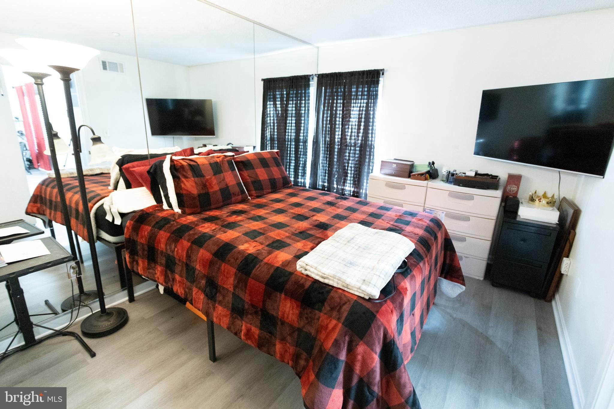 14111 Yardarm Way, Unit 1209 Laurel, MD 20707 - Photo 18 of 29 a bedroom with a bed and a flat screen tv