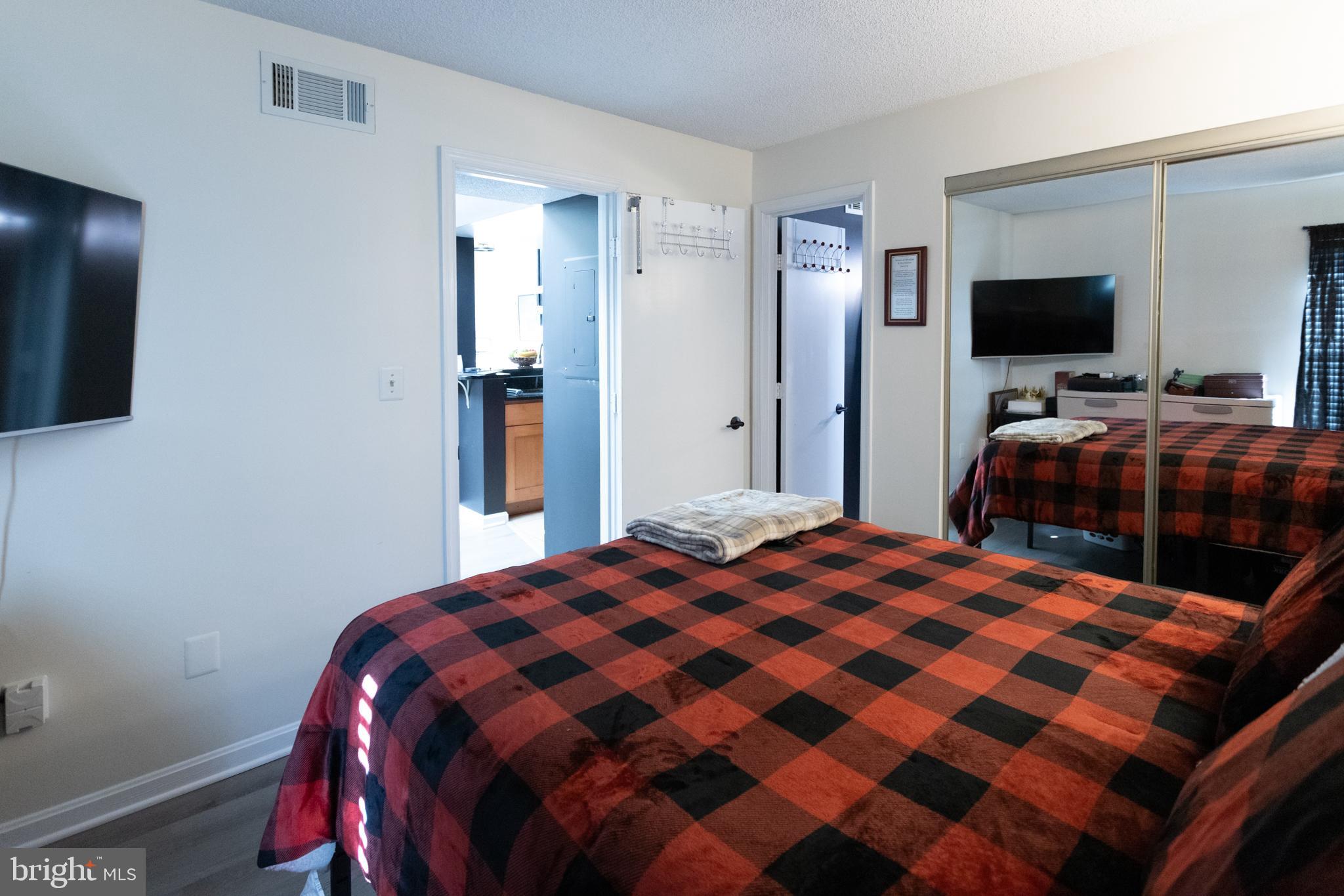 14111 Yardarm Way, Unit 1209 Laurel, MD 20707 - Photo 22 of 29 a bedroom with a bed and a flat screen tv