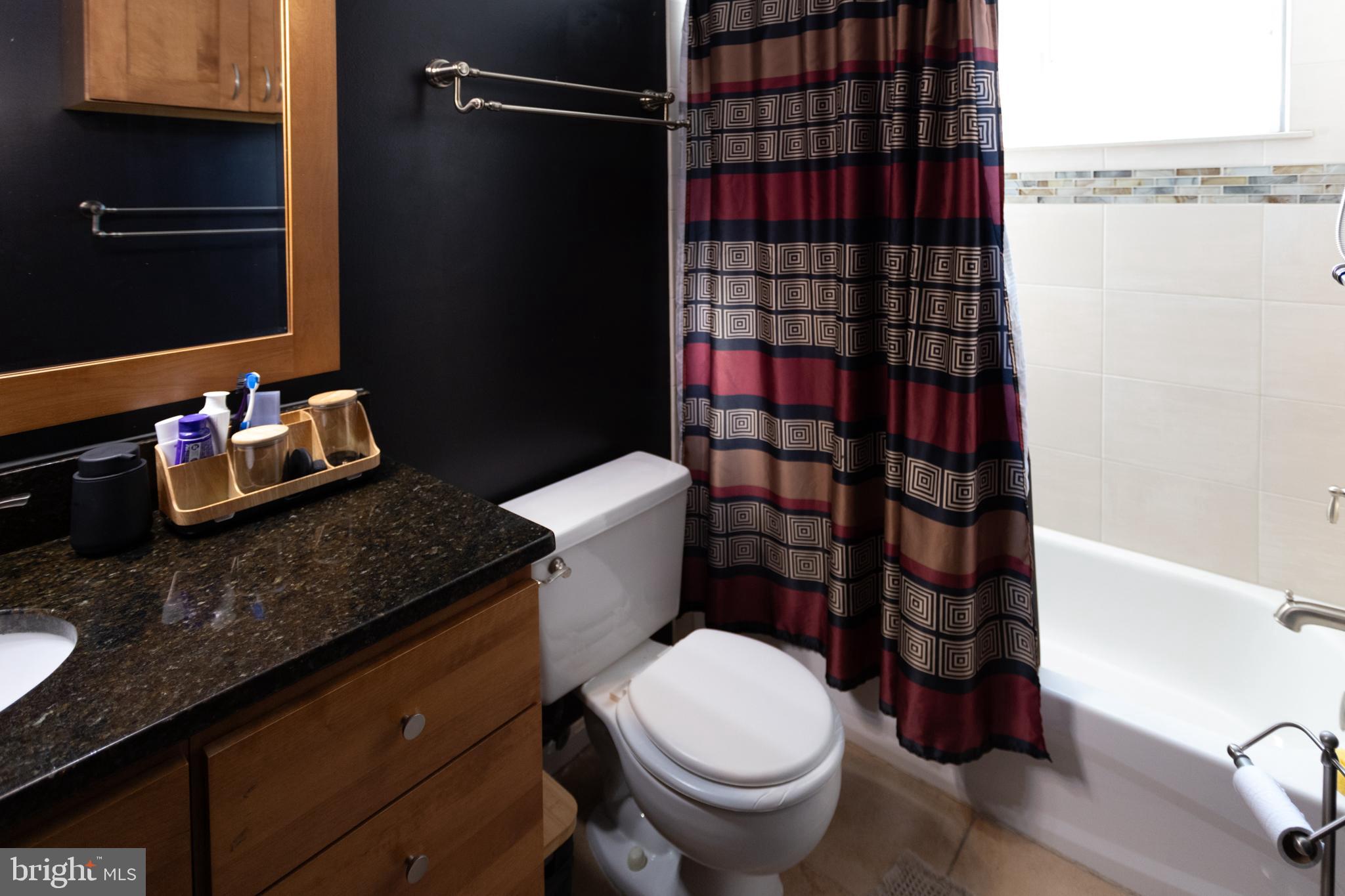 14111 Yardarm Way, Unit 1209 Laurel, MD 20707 - Photo 25 of 29 a bathroom with a granite countertop toilet and a shower