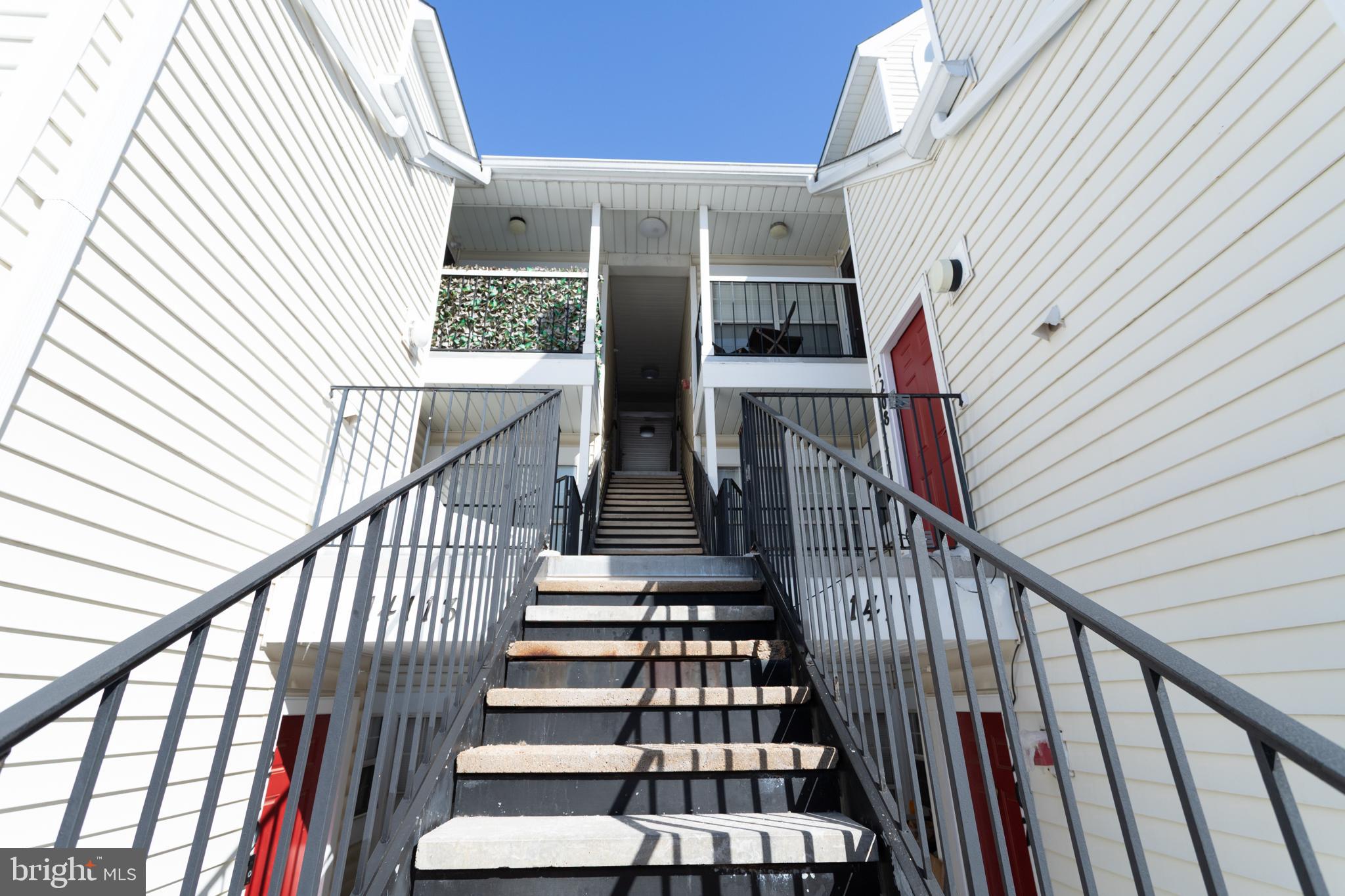 14111 Yardarm Way, Unit 1209 Laurel, MD 20707 - Photo 4 of 29 a view of staircase with wooden floor and white walls