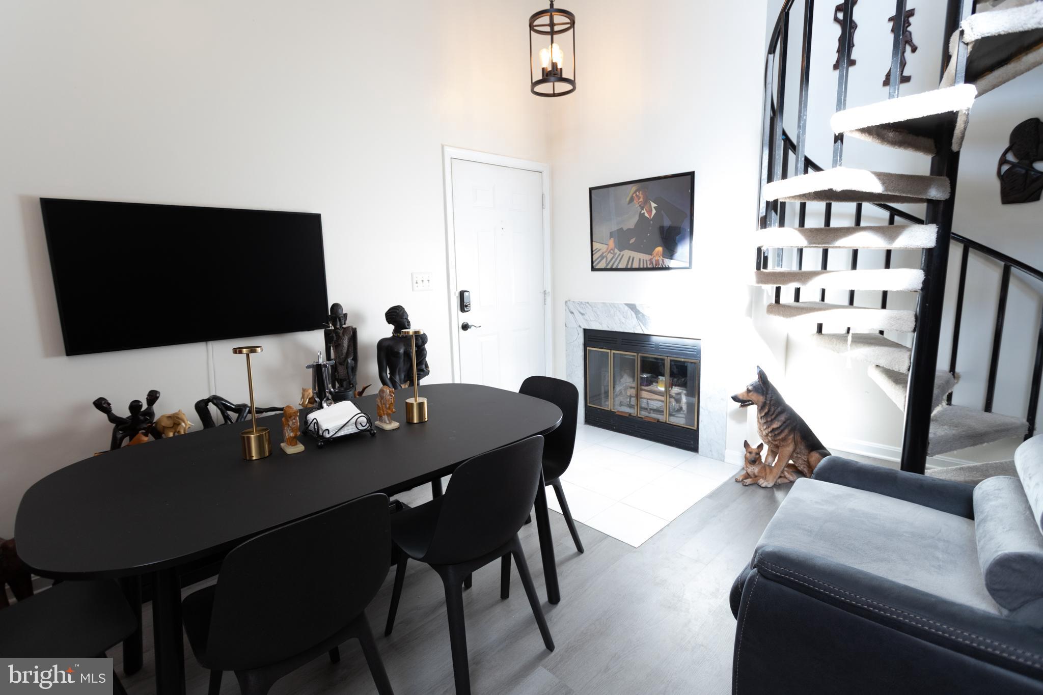 14111 Yardarm Way, Unit 1209 Laurel, MD 20707 - Photo 7 of 29 a living room with furniture flat screen tv and a fireplace