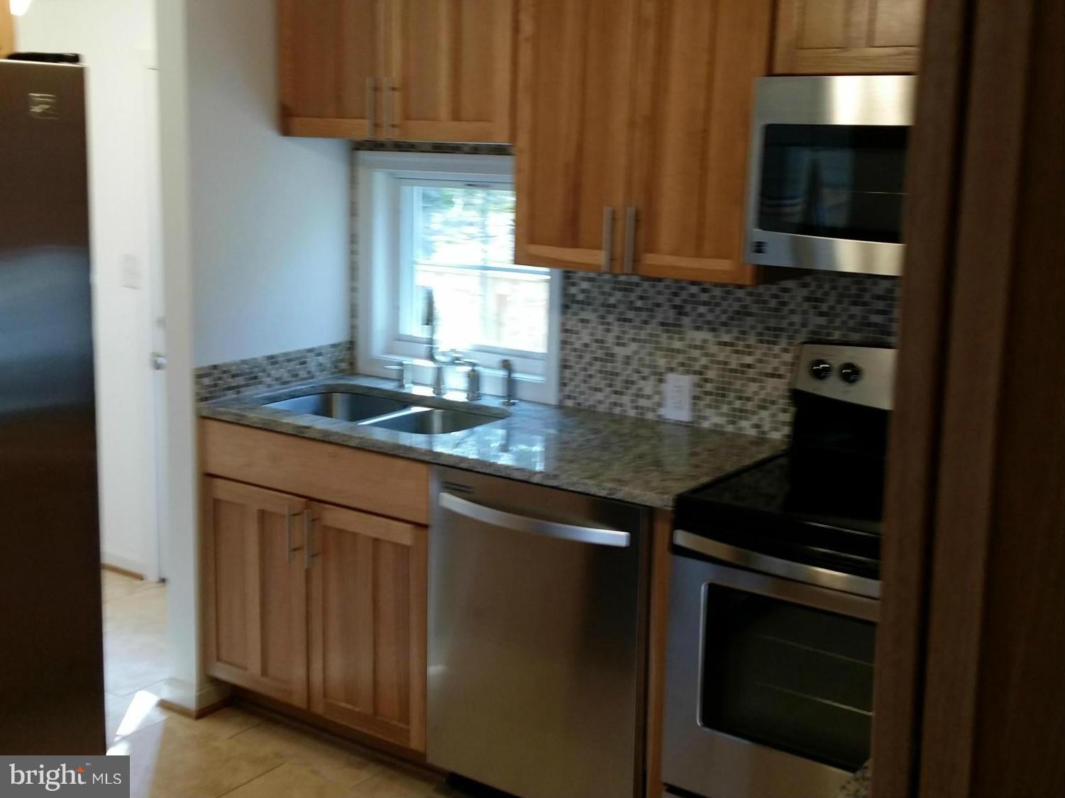 9250 Tetotum Road King George, VA 22485 - Photo 15 of 30 Tumbled marble, travertine, and glass back splash