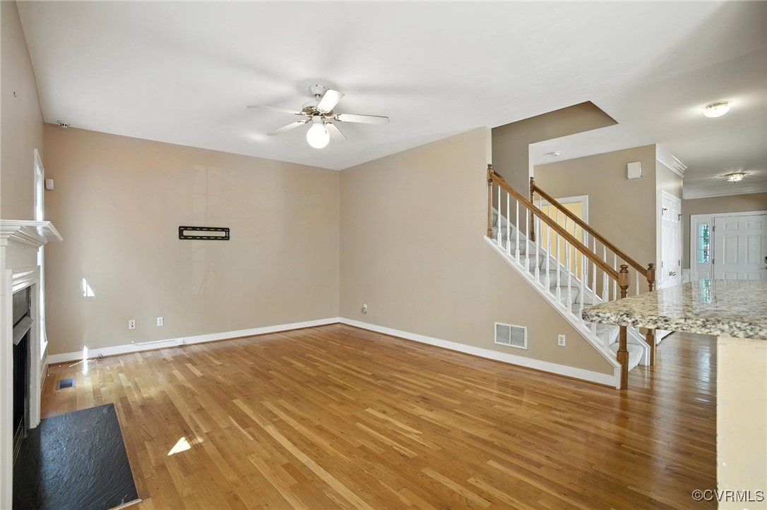8248 Hampton Arbor Circle Chesterfield, VA 23832 - Photo 12 of 41 a view of a room with wooden floor staircase and a ceiling fan