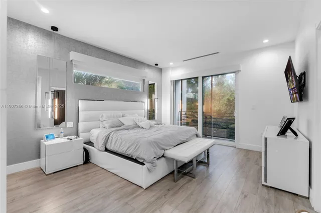 a bedroom with a bed and large window