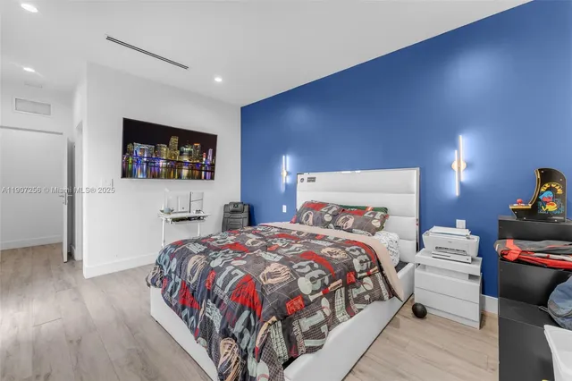 a bedroom with a bed and a flat screen tv