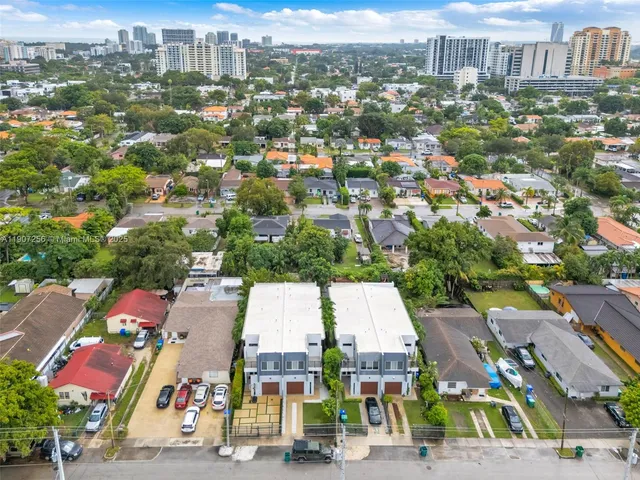 an aerial view of residential houses with city view