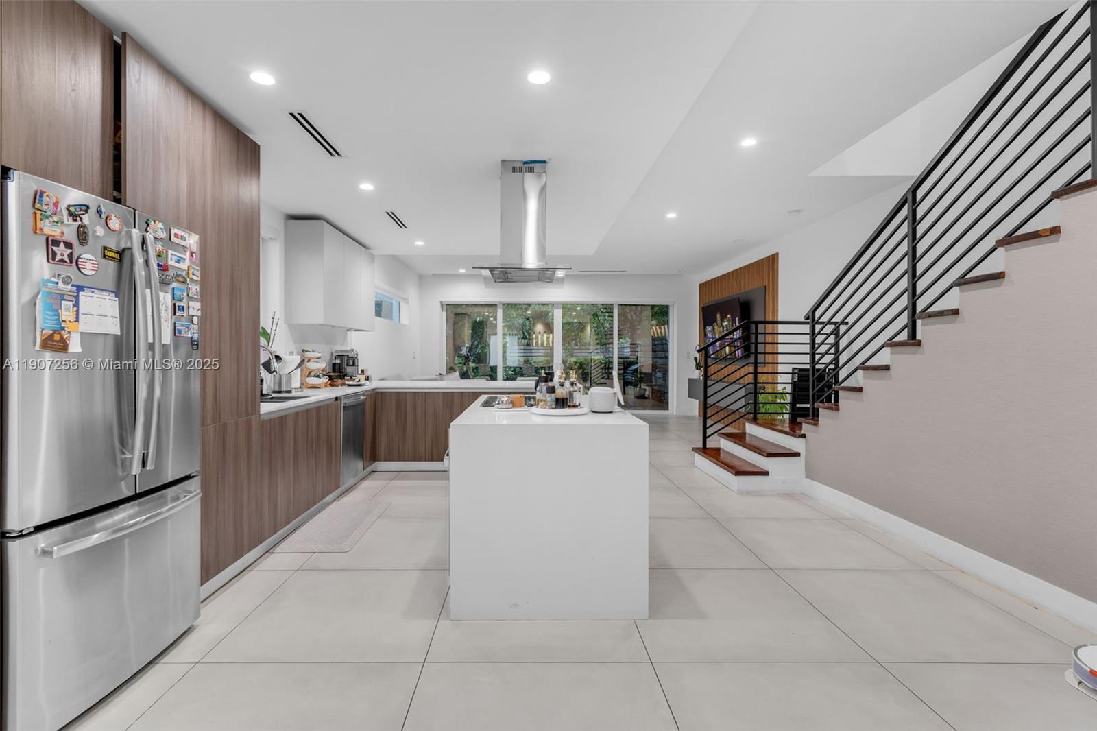 3048 Southwest 18th Street, Unit 3048 Miami, FL 33145 - Photo 5 of 39 a kitchen with stainless steel appliances kitchen island granite countertop a refrigerator a stove and a sink