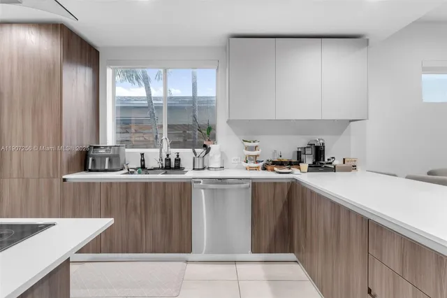 a kitchen with a sink window and cabinets