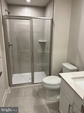 a bathroom with a shower and a toilet